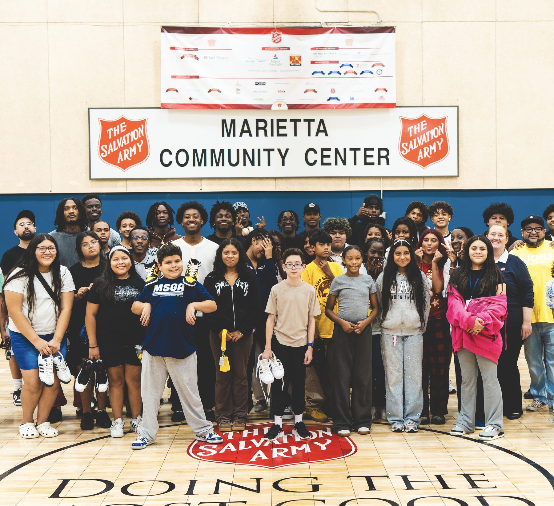 Sevenity Sports Group shoe drive with kids and volunteers at the Marietta Community Center